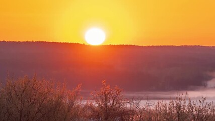 Poster - Timelapse video of sun rising above horizon in the morning. Spring morning video of sun rising illuminating the valley, melting fog