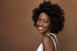 © LukaszDesign - Cosmetic, natural, and healthy facial routine for cheerful black woman in studio. Beautiful young African model having wellness facial or skin treatment on orange background.
