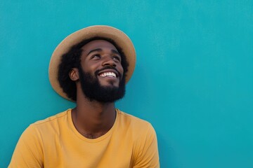 Black Teal Smile. African American Man with Beard in Casual Attire Looking at Blank Space on Cyan Background