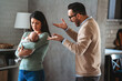 © NDABCREATIVITY - Family violence. Aggressive nervous man arguing with his wife who has postpartum depression