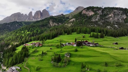 aerial view above val di tires, with the catinaccio - torri del vajolet rosengarten in the backgroun