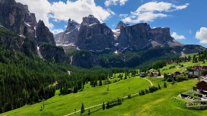 aerial view above val di tires, with the catinaccio - torri del vajolet rosengarten in the backgroun