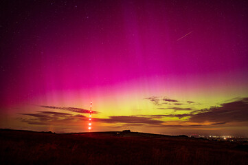 A view of The northern lights over the cumbrian countryside with a Meteor cutting through the sky.