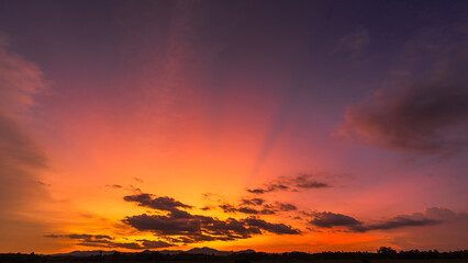 Sticker - Sunset sky clouds over silhouette hill countryside with orange, yellow sunlight sun rays in the evening on twilight dark blue, Horizon sky landscape, Dusk