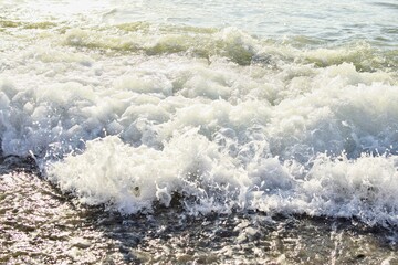 Big waves in the sea. Beautiful sea with splashes under the bright morning sunlight.