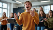 © altitudevisual - Young man leading a singing group during a choir practice session in a bright, modern room with natural light.