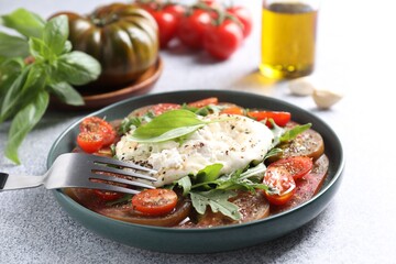 Sticker - Delicious fresh burrata salad in bowl served on light gray textured table, closeup