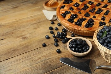 Wall Mural - Tasty homemade pie with blueberries served on wooden table. Space for text