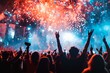 © woters - Crowd celebrating with raised hands during a vibrant fireworks display at a nighttime festival