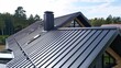 © Cambo27 - Roofer installing metal roofing sheets on a residential house