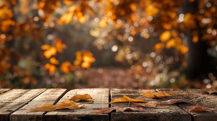 Poster - Rustic wooden table with blurred autumn background and golden yellow old leaves, autumn table background copy space
