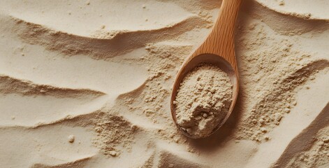 Close-up of wooden spoon and container filled with brown protein powder on the table. Representing the idea that you can make your own protein drink, nutrition, muscle growth, banner with copy space.