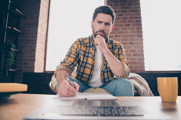 Sticker - Photo of uncertain thoughtful guy dressed checkered shirt writing book reading modern device indoors house apartment room