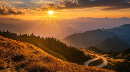 Poster - A sunset view of a mountain road with the sun casting a warm glow over the landscape, highlighting the winding path and the surrounding mountain scenery.