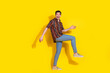 © deagreez - Full length portrait of nice young man walk empty space wear shirt isolated on yellow color background