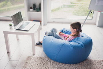 Poster - Full size photo of small cute daughter remote education sit bean bag home schooling isolated indoors