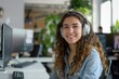 © NikoG - Portrait of a smiling young Hispanic female IT support worker in startup company office