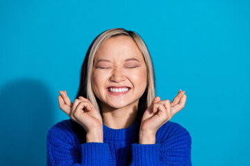 Wall Mural - Photo portrait of lovely young lady hope make wish dressed stylish knitwear garment isolated on blue color background