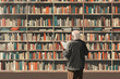 © Nelly - Elderly man reading in a large, cozy library