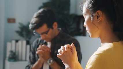 Wall Mural - Top view of skilled diverse prayer clasping hand and praying to god while sitting at chair in circle. Top down aerial view of people folded hand while sitting with opened bible on laps. Symposium.