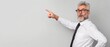 © best stock - businessman pointing at copy space for advertising
