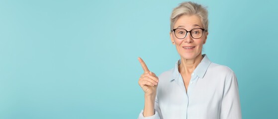 Wall Mural - miling 40 year business woman pointing, room for text, light blue background --ar 7:3 --style raw --personalize m3smyak --v 6 Job ID: 3c5f5ac2-a4f4-48bb-a1a3-5ce0ec95d507