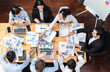 © InfiniteFlow - Panorama top view diverse group of business analyst team analyzing financial data report paper on meeting table. Chart and graph dashboard by business intelligence analysis. Meticulous