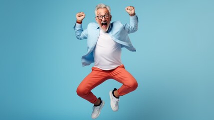 Caucasian Senior grey haired man jumping over blue background very happy and excited doing winner gesture with arms raised, smiling and screaming for success. celebration concept. Happy elderly man