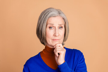 Sticker - Photo portrait of nice senior woman thoughtful skeptical wear trendy blue outfit isolated on beige color background