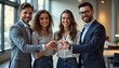 © tinybrushcreations - 4 young professional adults smiling and making a heart shape with their hands in an office setting