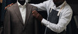 © Parilov - Custom made high quality tailored fashion suit by designer on mannequin. African American tailor working on luxury workshop of tailoring bespoke atelier