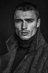 Canvas Print - Black and white portrait of a male model in a turtleneck and coat