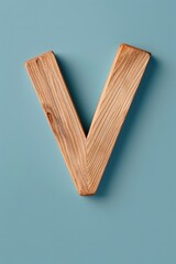 Aufkleber - A simple wooden letter V against a bright blue background, suitable for use in branding or design concepts