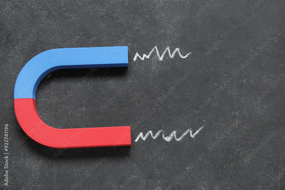 Horseshoe shaped magnet on grunge black background