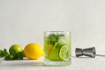 Wall Mural - Glass of tasty lemonade with mint, lime and lemon on white background