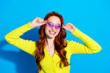 Wall Mural - Photo portrait of attractive young woman sunglass summer vacation dressed stylish yellow clothes isolated on blue color background