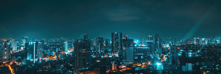 Wall Mural - A breathtaking view of city buildings illuminated by bright lights against a dark sky during nighttime