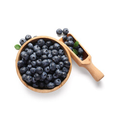 Canvas Print - Wooden bowl and scoop with ripe blueberry on white background, closeup