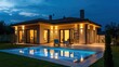 © vladimir - Elegant modern house with an illuminated swimming pool, glowing exterior lights, and a tranquil garden setting under the night sky.