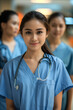 © Starmarpro - Portrait of young Philippino nurse or a doctor intern with colleagues. High quality photo