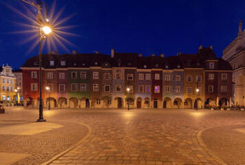 Wall Mural - Facades of old multi-colored houses on the Town Hall Square in Poznan at dawn