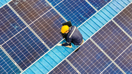 Worker Technicians are working to construct solar panels system on roof. Installing solar photovoltaic panel system. Men technicians walking on roof structure to check photovoltaic solar modules.