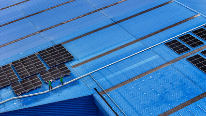 Wall Mural - Worker Technicians are working to construct solar panels system on roof. Installing solar photovoltaic panel system. Men technicians walking on roof structure to check photovoltaic solar modules.