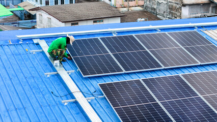 Wall Mural - Worker Technicians are working to construct solar panels system on roof. Installing solar photovoltaic panel system. Men technicians walking on roof structure to check photovoltaic solar modules.