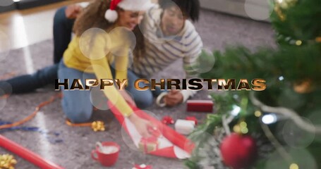 Sticker - Wrapping gifts, couple sitting on floor with HAPPY CHRISTMAS animation over scene