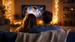 © Nathaphat - Cozy Evening at Home: Young Couple Watching Romantic Comedy with Candlelit Ambiance on Sofa