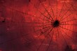 © Your Background - Black spider web covering a scary red grunge background with blank space for halloween design projects