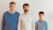 © Prostock-studio - Male Generations. Serious Boy, Father And Grandfather Standing Looking At Camera Against White Wall Indoor. Panorama