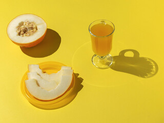 Wall Mural - Fresh Melon and Juice on Bright Yellow Background - Vibrant and Refreshing Summer Vibes