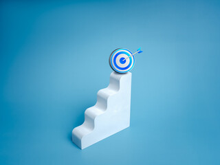 Wall Mural - Blue 3d goal target icon on top white modern geometric stairway as graph steps, isolated on blue background, minimalist. Business growth, profit financial, investment, marketing and trends concepts.